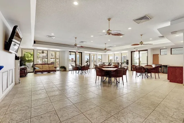 a view of a dining room with furniture and a chandelier