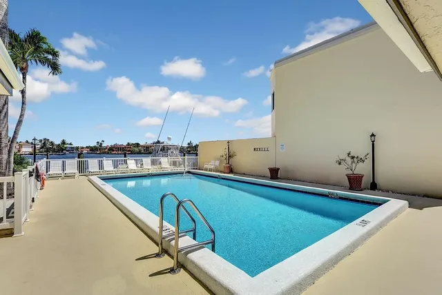 a view of a swimming pool and lounge chair