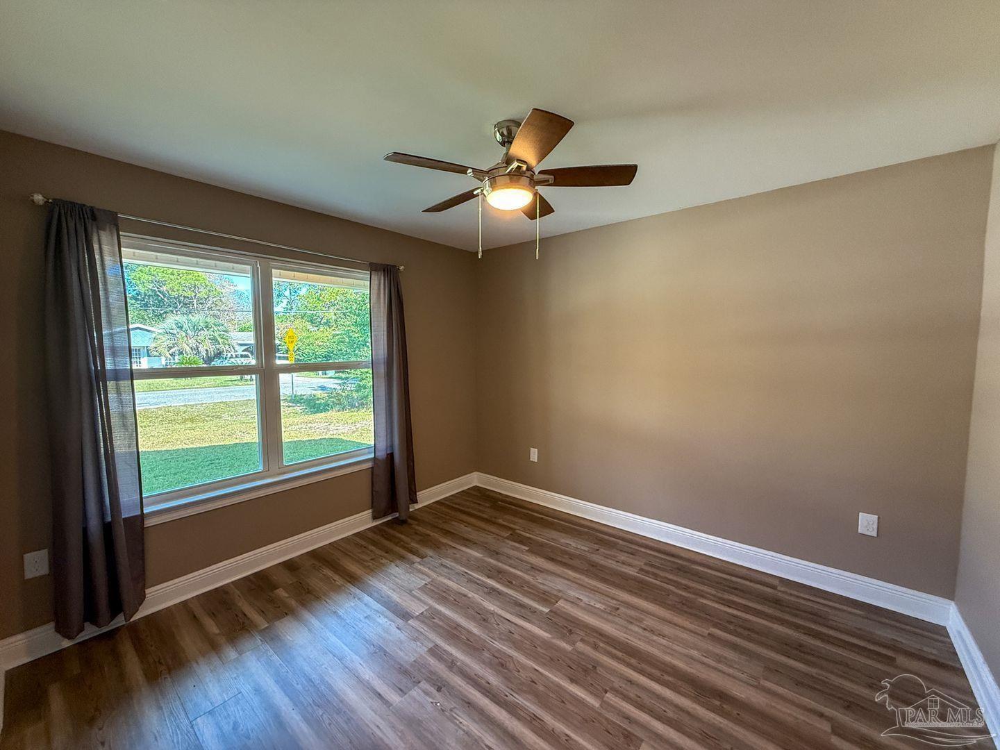 10423 Tanton Road Pensacola, FL 32506 - Photo 13 of 19 wooden floor in an empty room with a window