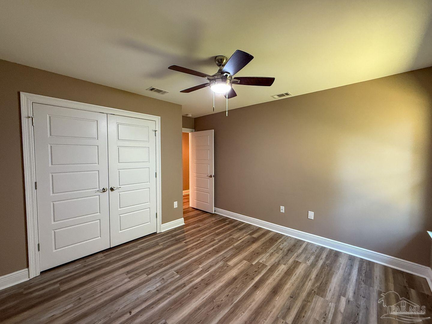 10423 Tanton Road Pensacola, FL 32506 - Photo 15 of 19 a view of an empty room and wooden floor