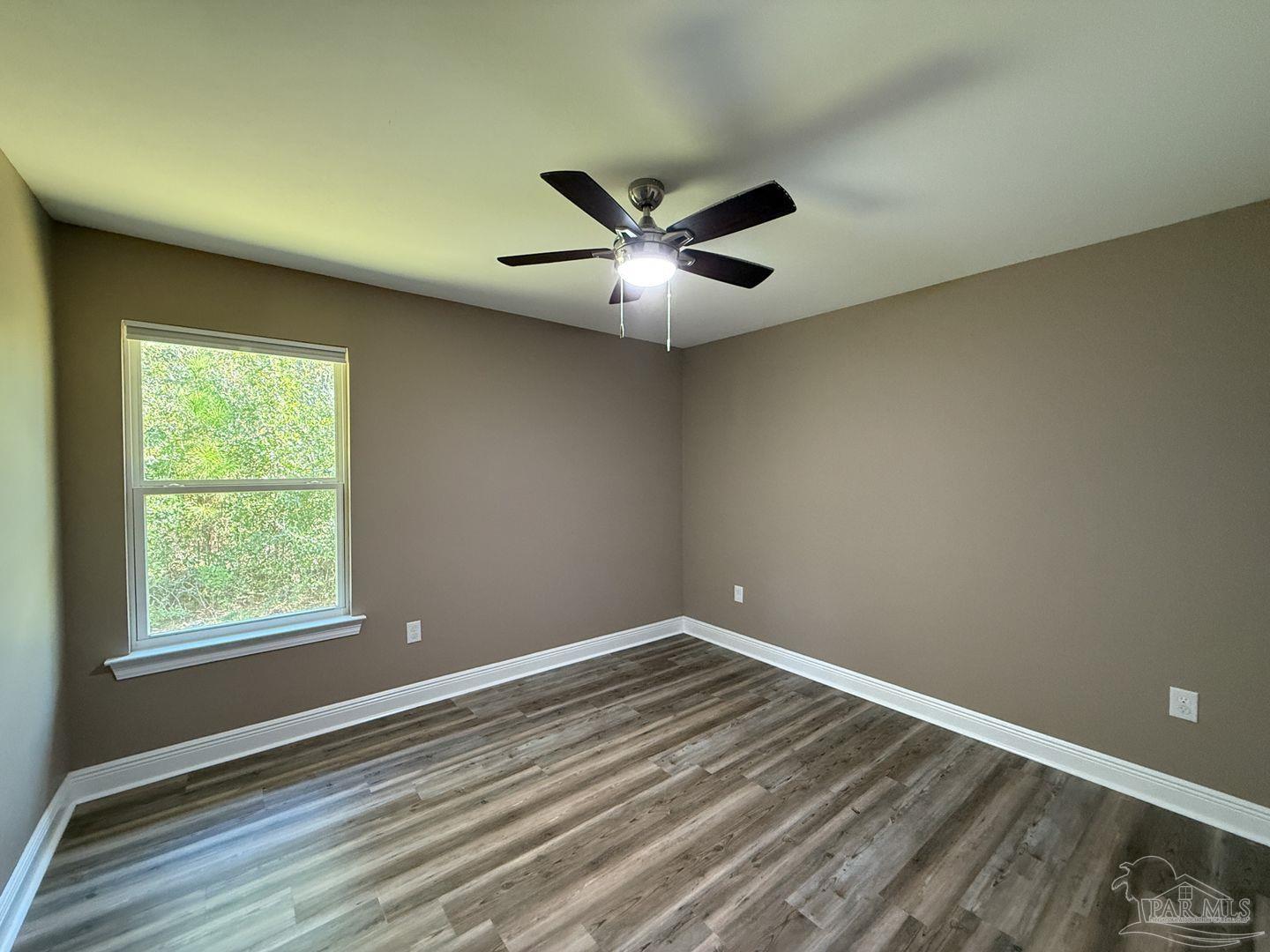 10423 Tanton Road Pensacola, FL 32506 - Photo 16 of 19 an empty room with a window and a fan