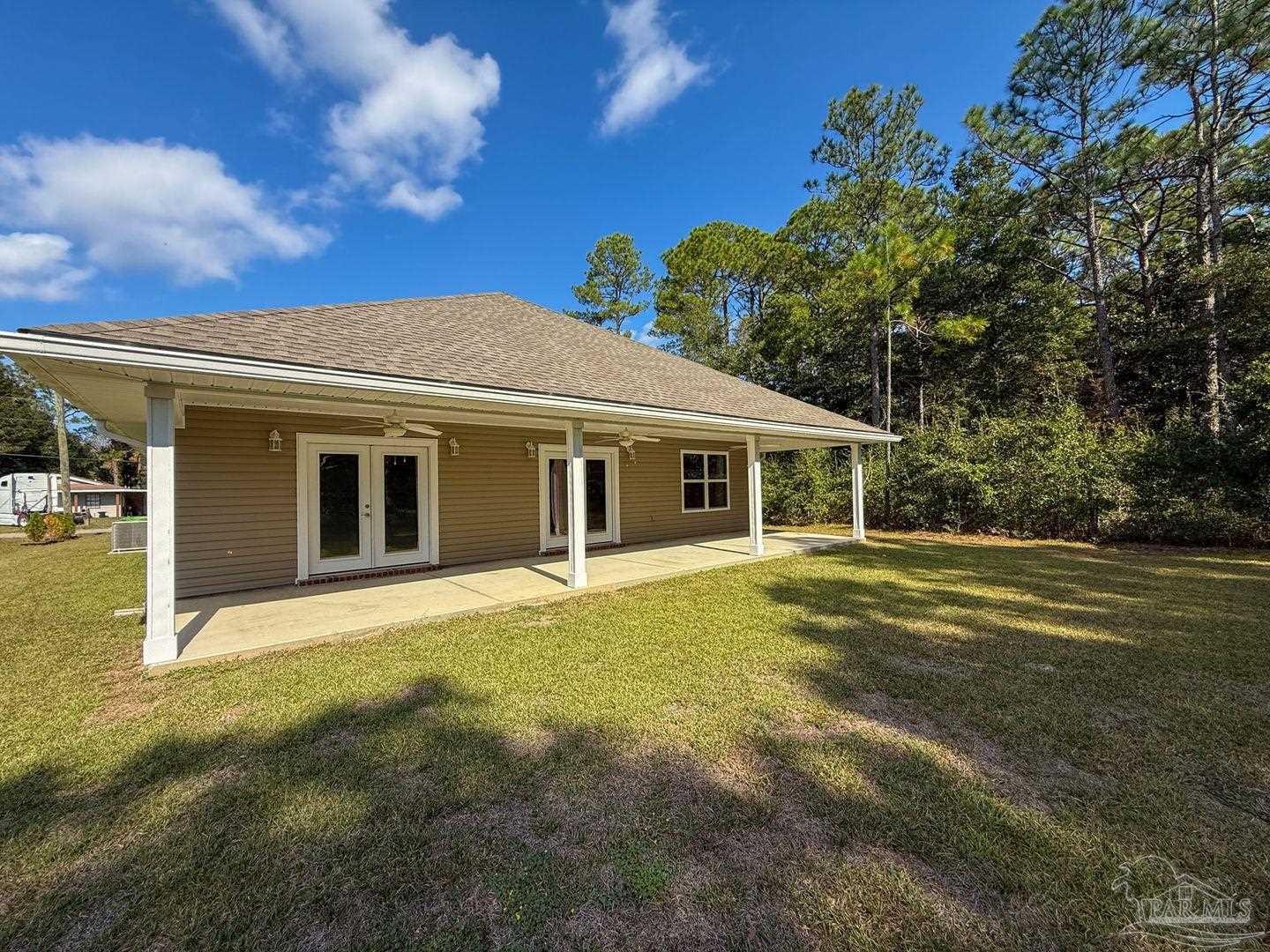 10423 Tanton Road Pensacola, FL 32506 - Photo 18 of 19 a front view of a house with a garden