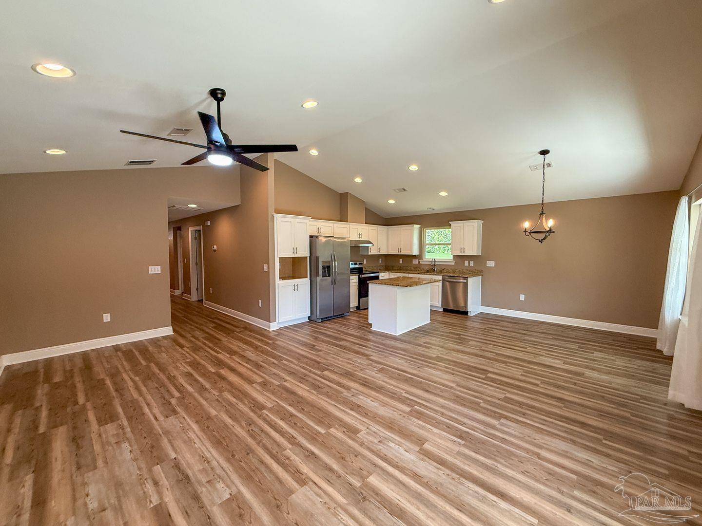 10423 Tanton Road Pensacola, FL 32506 - Photo 3 of 19 a view of a room with kitchen island stainless steel appliances wooden floor and living room view