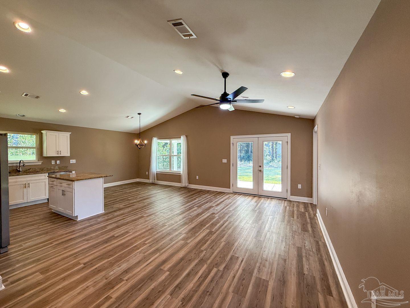 10423 Tanton Road Pensacola, FL 32506 - Photo 4 of 19 a view of an empty room with window and wooden floor