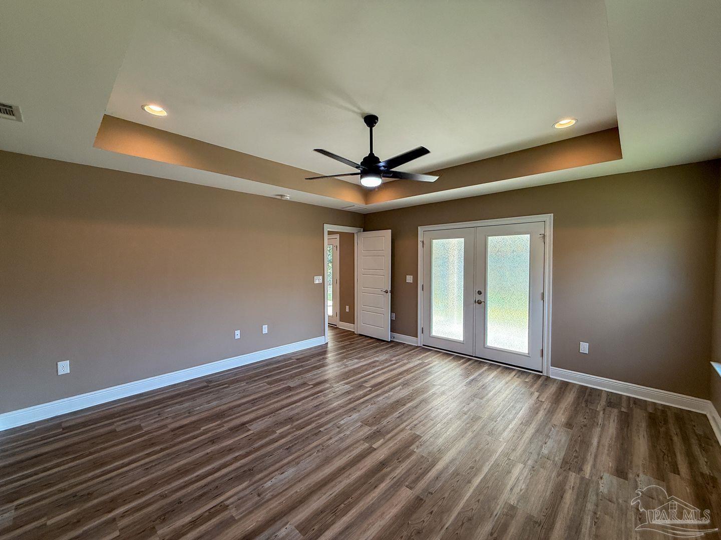 10423 Tanton Road Pensacola, FL 32506 - Photo 7 of 19 a view of an empty room with window and wooden floor