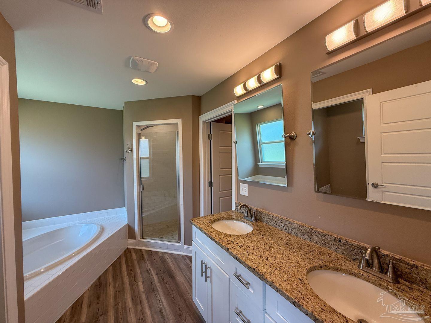 10423 Tanton Road Pensacola, FL 32506 - Photo 9 of 19 a bathroom with a granite countertop sink mirror and a bathtub