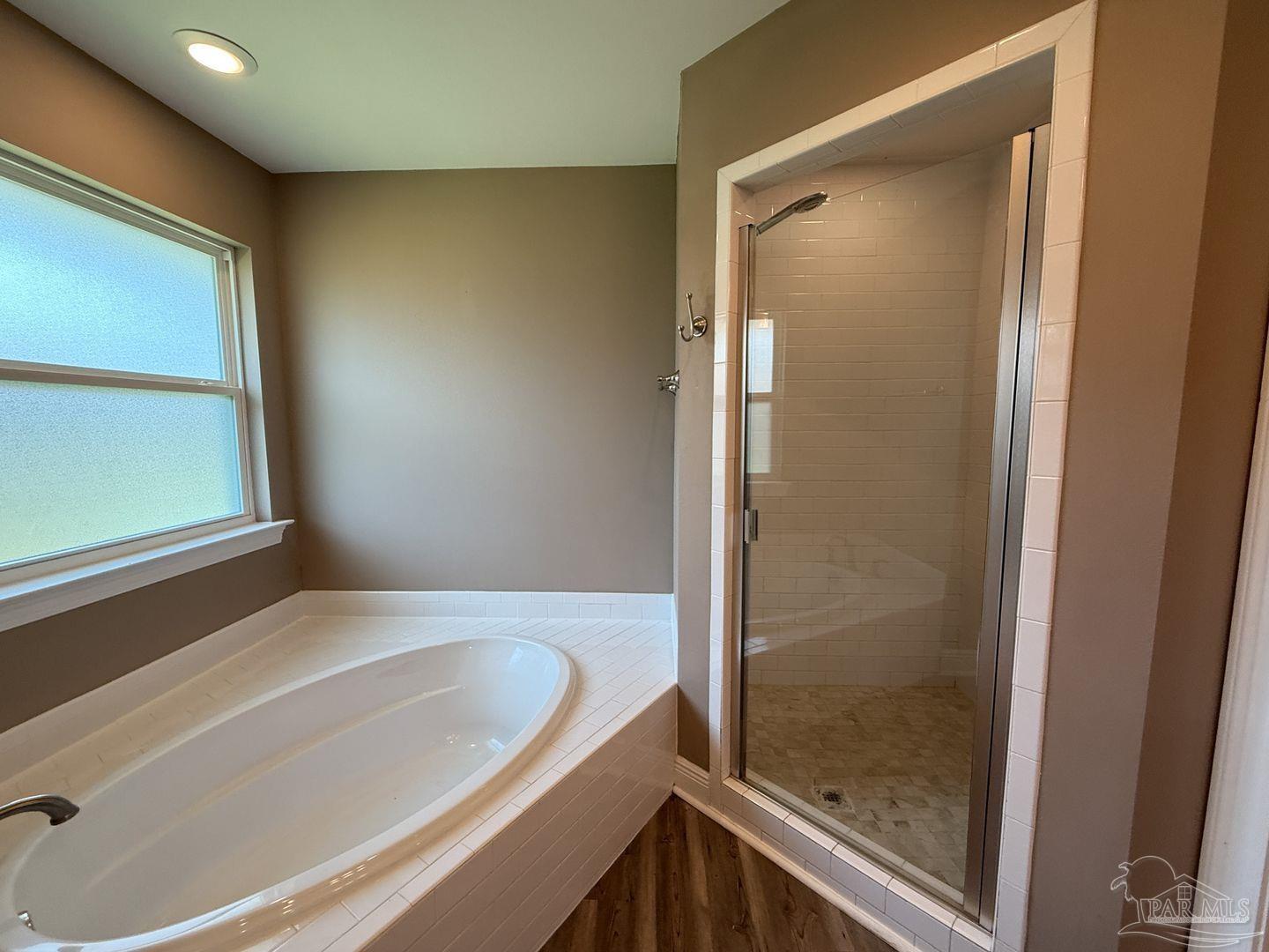 10423 Tanton Road Pensacola, FL 32506 - Photo 10 of 19 a bathroom with a bathtub and a shower