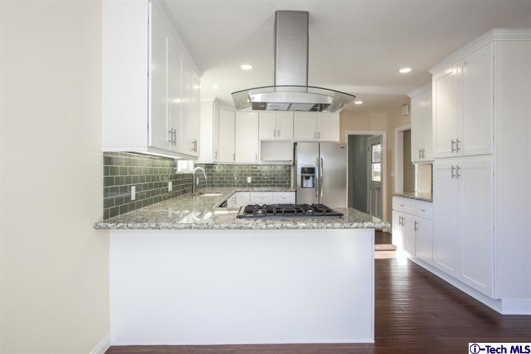 4465 Rising Hill Road Altadena, CA 91001 - Photo 14 of 45 a kitchen with stainless steel appliances granite countertop a sink a refrigerator and a stove