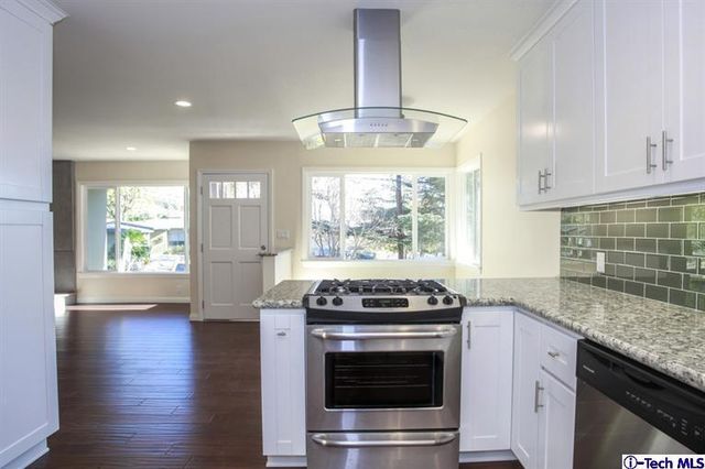 a kitchen with granite countertop a stove and a sink