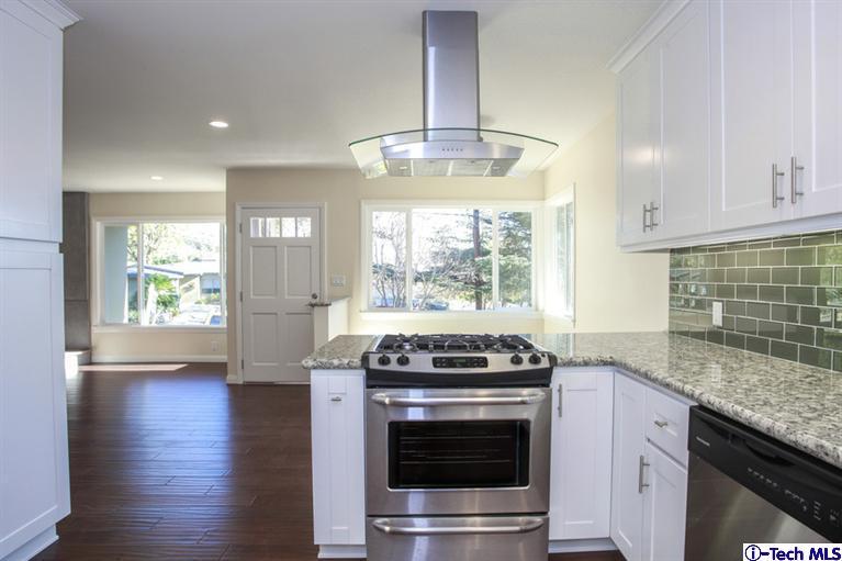 4465 Rising Hill Road Altadena, CA 91001 - Photo 17 of 45 a kitchen with granite countertop a stove and a sink