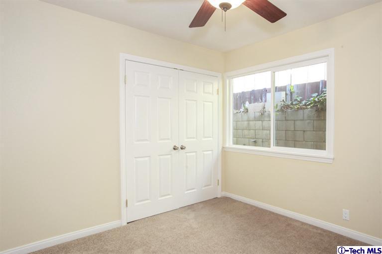 4465 Rising Hill Road Altadena, CA 91001 - Photo 28 of 45 an empty room with a window and a fan