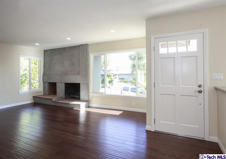4465 Rising Hill Road Altadena, CA 91001 - Photo 4 of 45 an empty room with wooden floor fireplace and windows