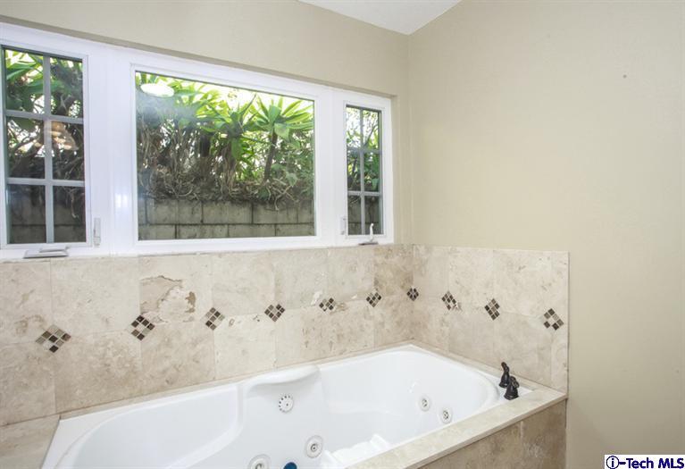 4465 Rising Hill Road Altadena, CA 91001 - Photo 33 of 45 a bathroom with bathtub and window