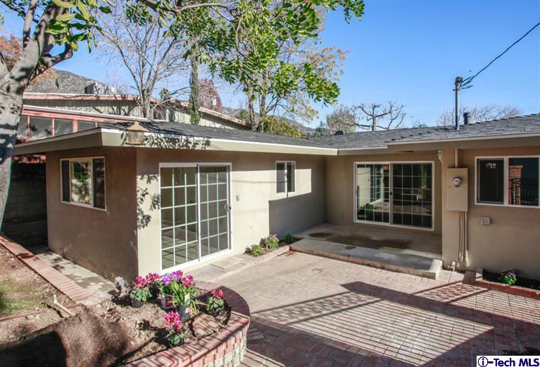 4465 Rising Hill Road Altadena, CA 91001 - Photo 34 of 45 a front view of a house with a garden