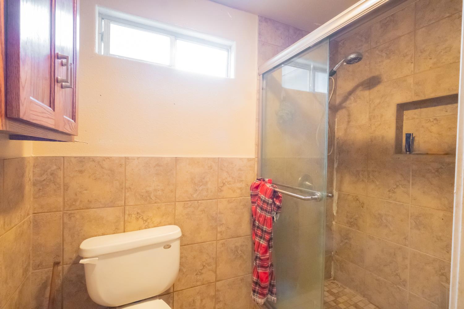 6401 South Chestnut Avenue Fresno, CA 93725 - Photo 17 of 36 a bathroom with a toilet and a shower