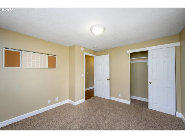 a big room with closet and windows