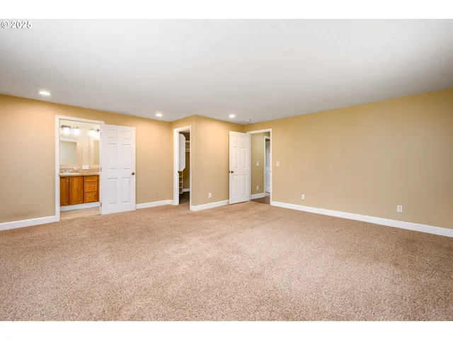a view of an empty room with a kitchen