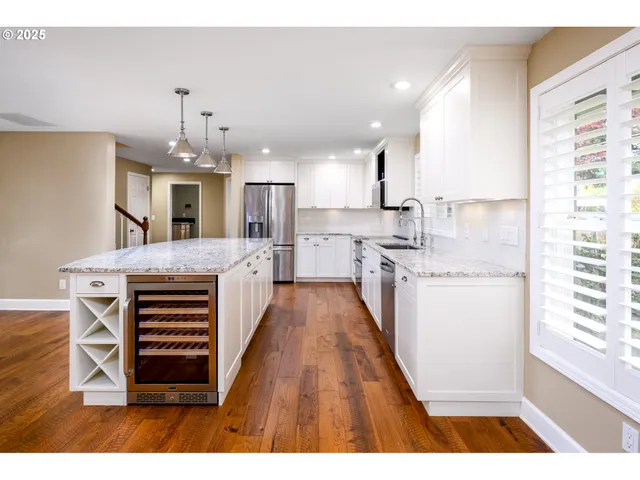 a view of kitchen with sink microwave and refrigerator