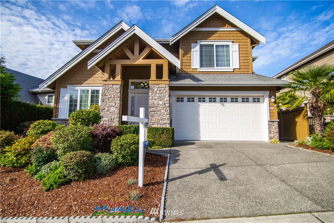 1026 South 36th Place Renton, WA 98055 - Photo 1 of 25 a front view of a house with a yard and garage