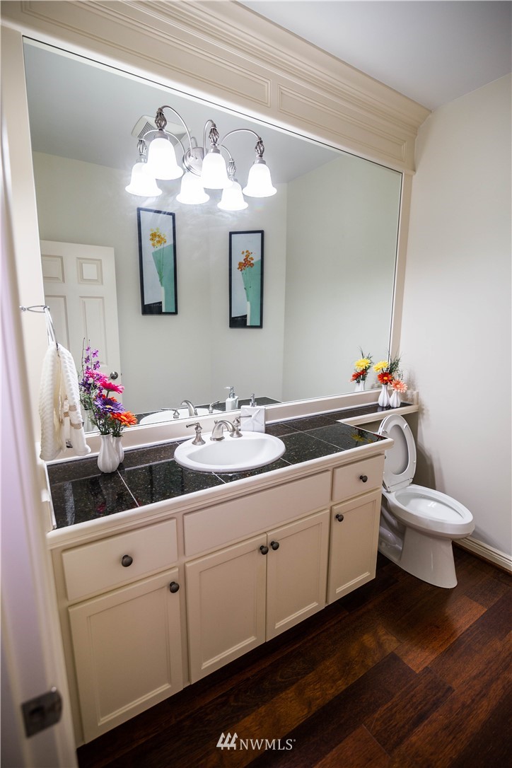 1026 South 36th Place Renton, WA 98055 - Photo 12 of 25 a bathroom with a double vanity sink and a mirror