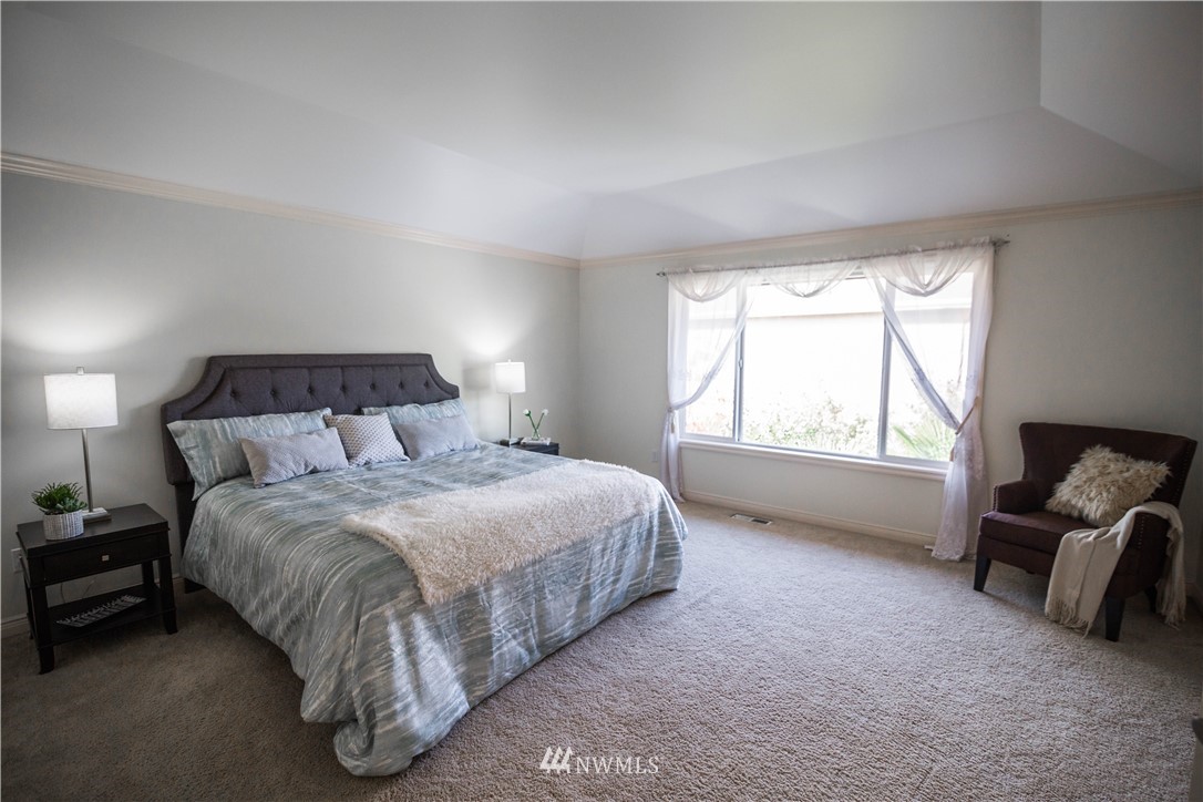1026 South 36th Place Renton, WA 98055 - Photo 15 of 25 a bedroom with a bed and a chair