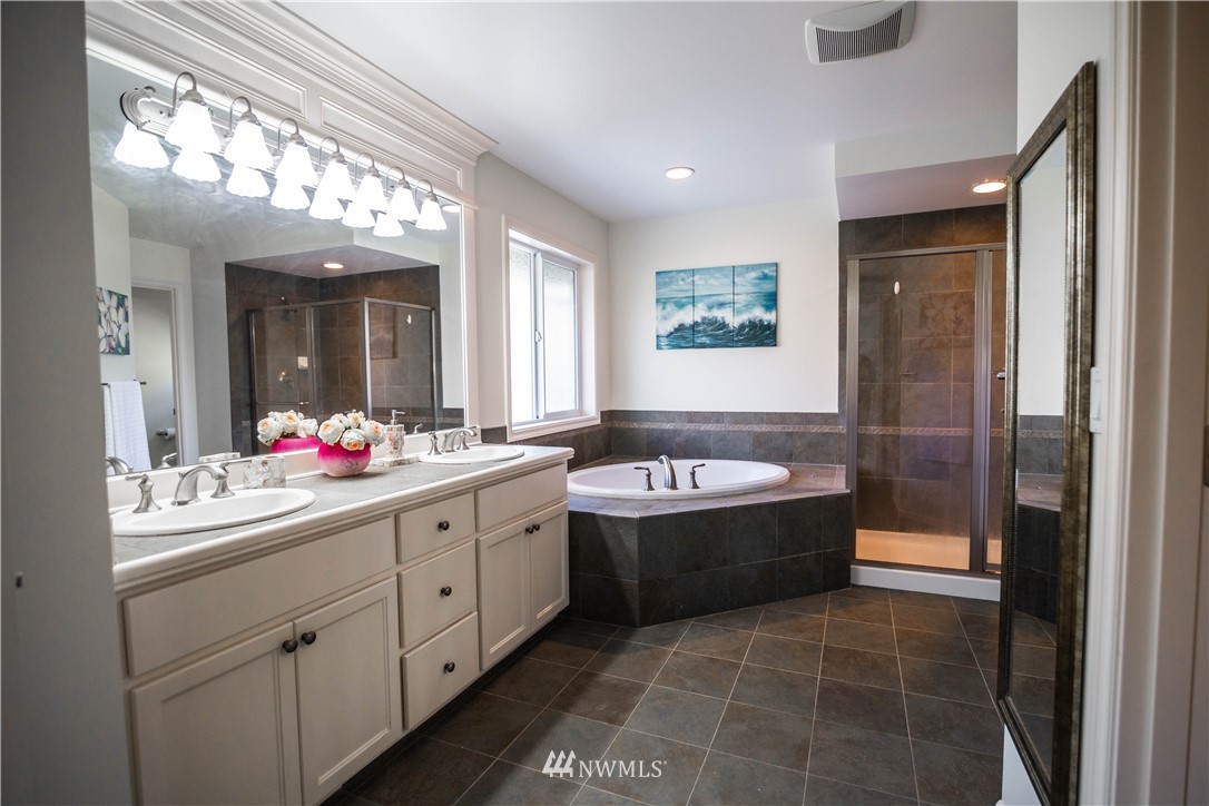 1026 South 36th Place Renton, WA 98055 - Photo 17 of 25 a bathroom with a tub sink and mirror