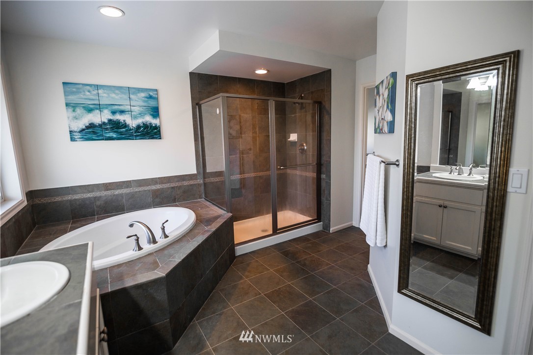 1026 South 36th Place Renton, WA 98055 - Photo 18 of 25 a bathroom with a bathtub and a shower