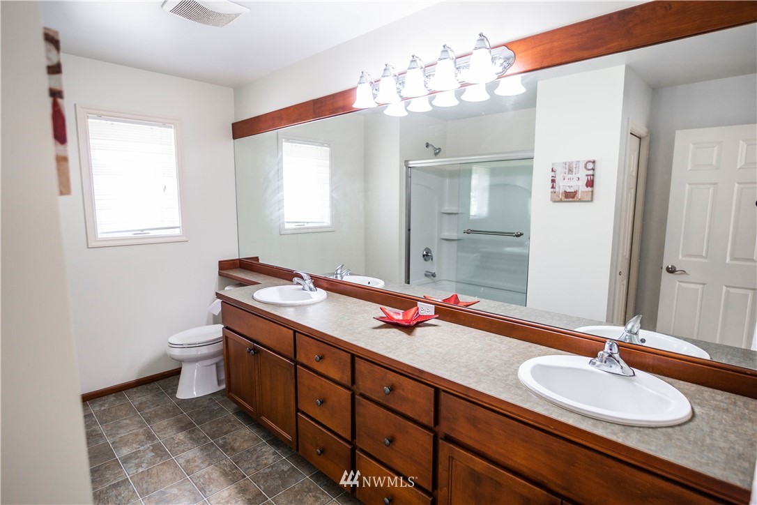 1026 South 36th Place Renton, WA 98055 - Photo 23 of 25 a bathroom with a double vanity sink and a mirror