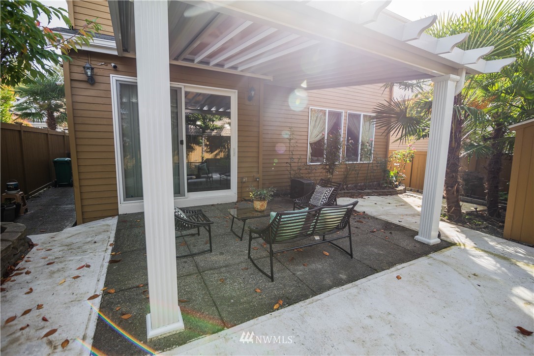 1026 South 36th Place Renton, WA 98055 - Photo 25 of 25 a view of a patio with table and chairs and potted plants