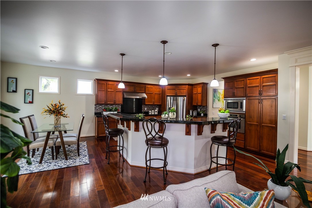 1026 South 36th Place Renton, WA 98055 - Photo 9 of 25 a view of a dining room with furniture window and wooden floor
