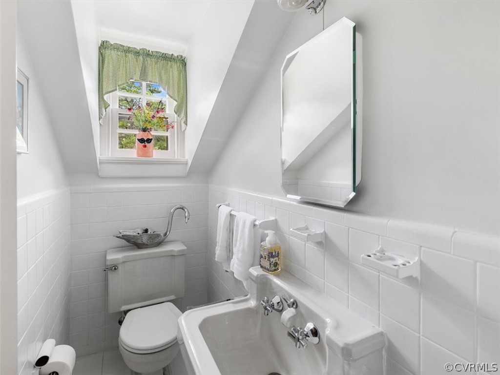 7100 River Road Henrico, VA 23229 - Photo 19 of 32 a bathroom with a toilet sink and mirror