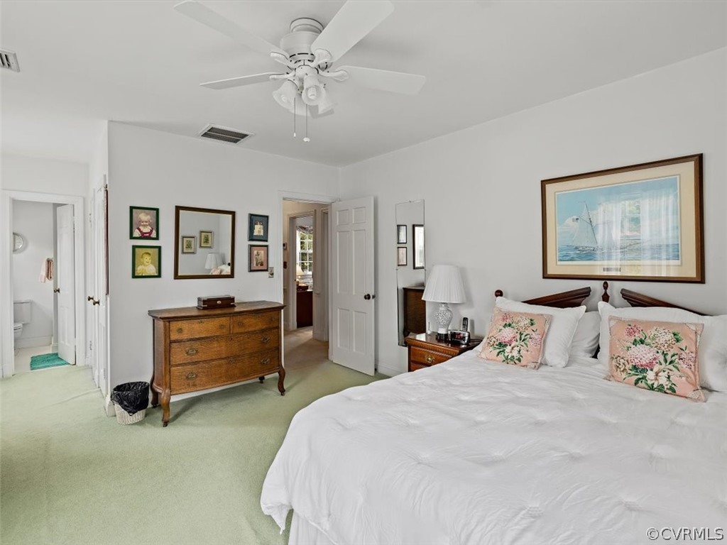 7100 River Road Henrico, VA 23229 - Photo 21 of 32 a bedroom with a bed and a chandelier