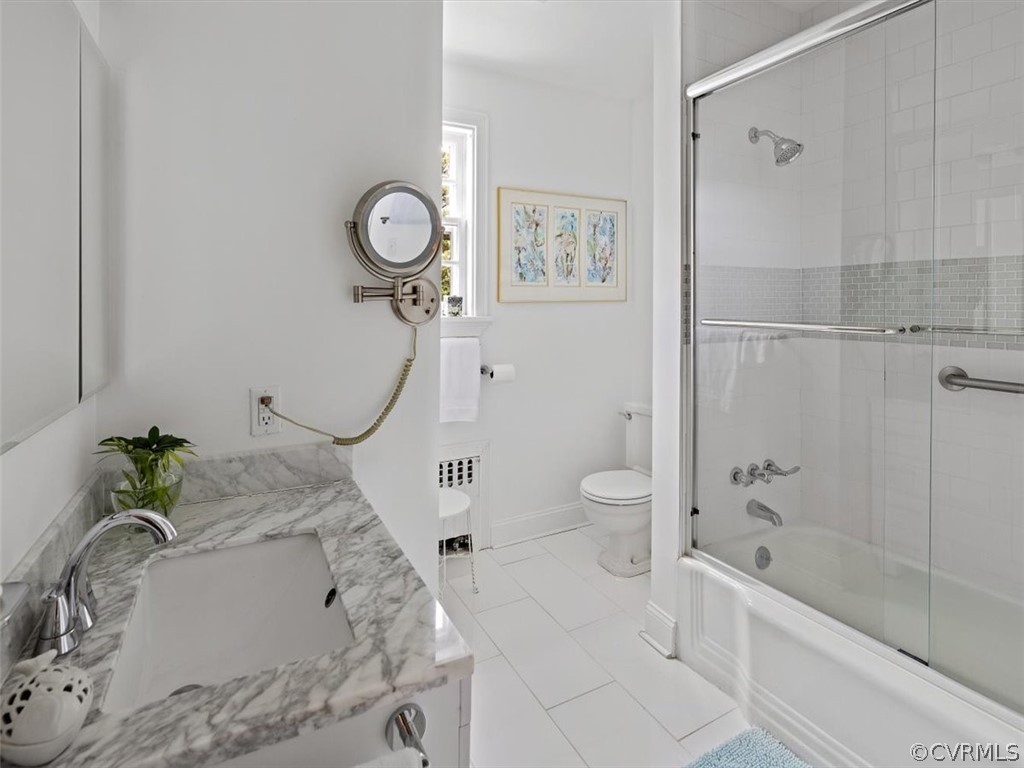 7100 River Road Henrico, VA 23229 - Photo 25 of 32 a bath tub sitting next to a white sink and a shower