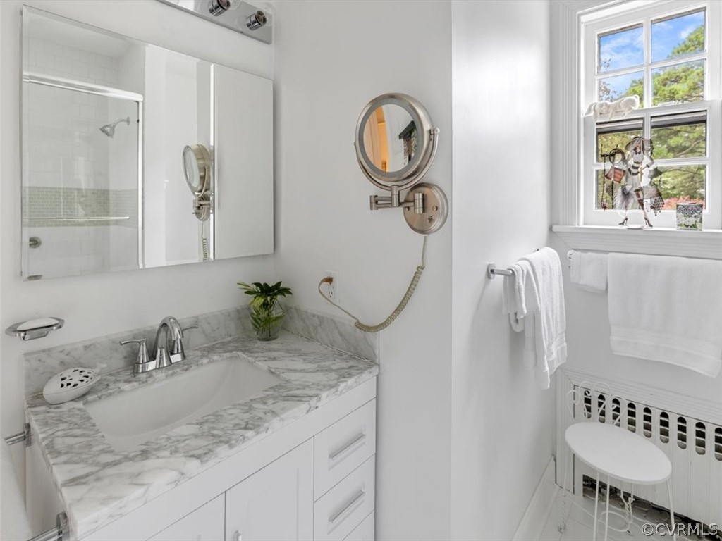 7100 River Road Henrico, VA 23229 - Photo 26 of 32 a bathroom with a granite countertop sink and a mirror