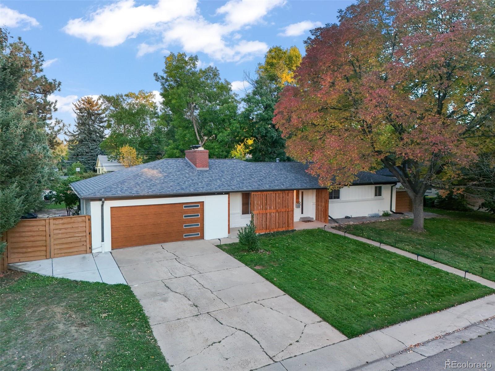 a front view of a house with a yard and trees