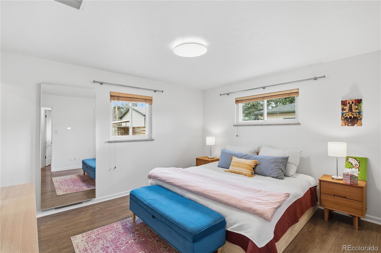 5974 South Pennsylvania Street Centennial, CO 80121 - Photo 13 of 46 a bedroom with a bed and wooden floor