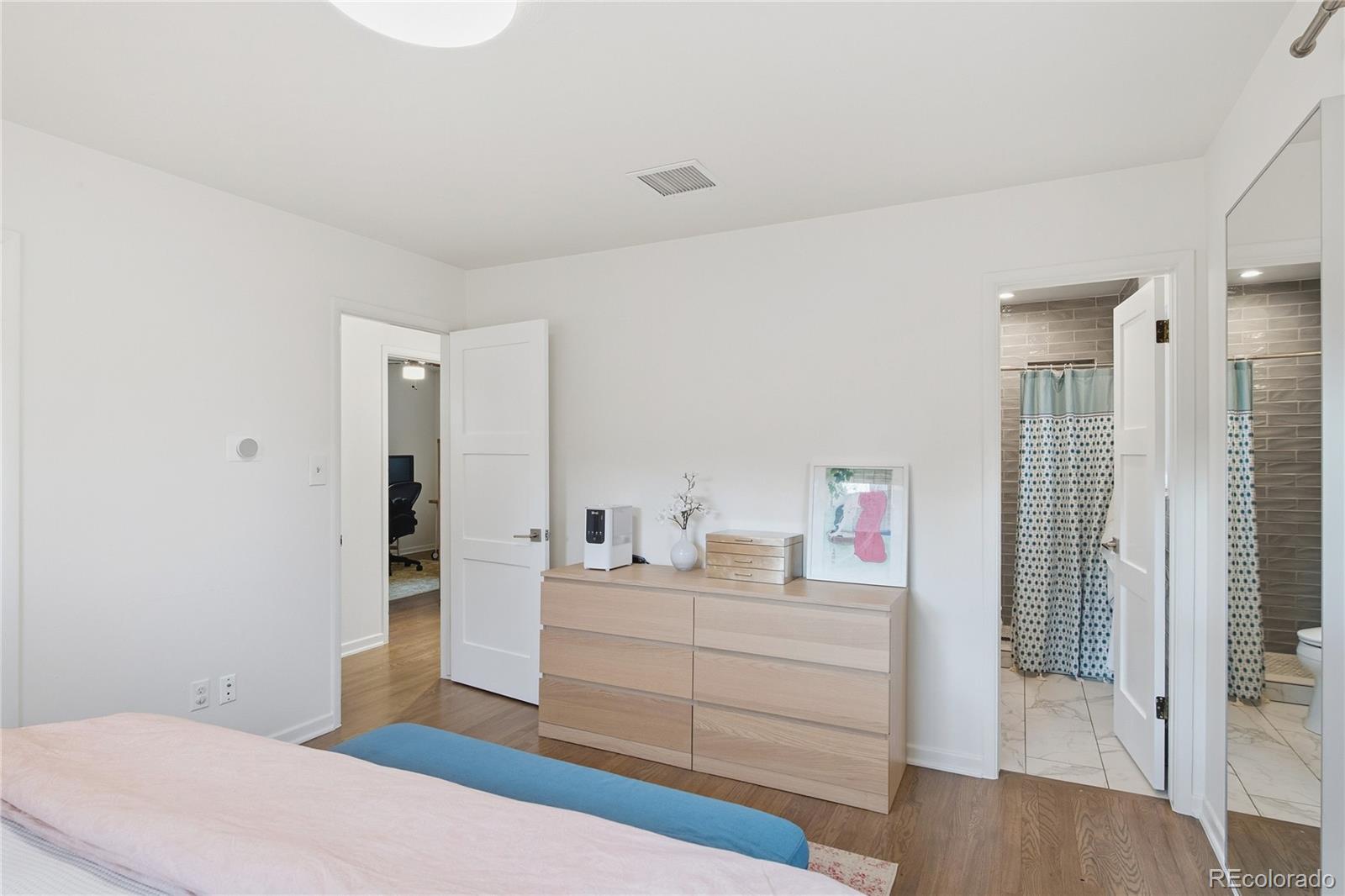 5974 South Pennsylvania Street Centennial, CO 80121 - Photo 14 of 46 a bedroom with a bed and a dresser