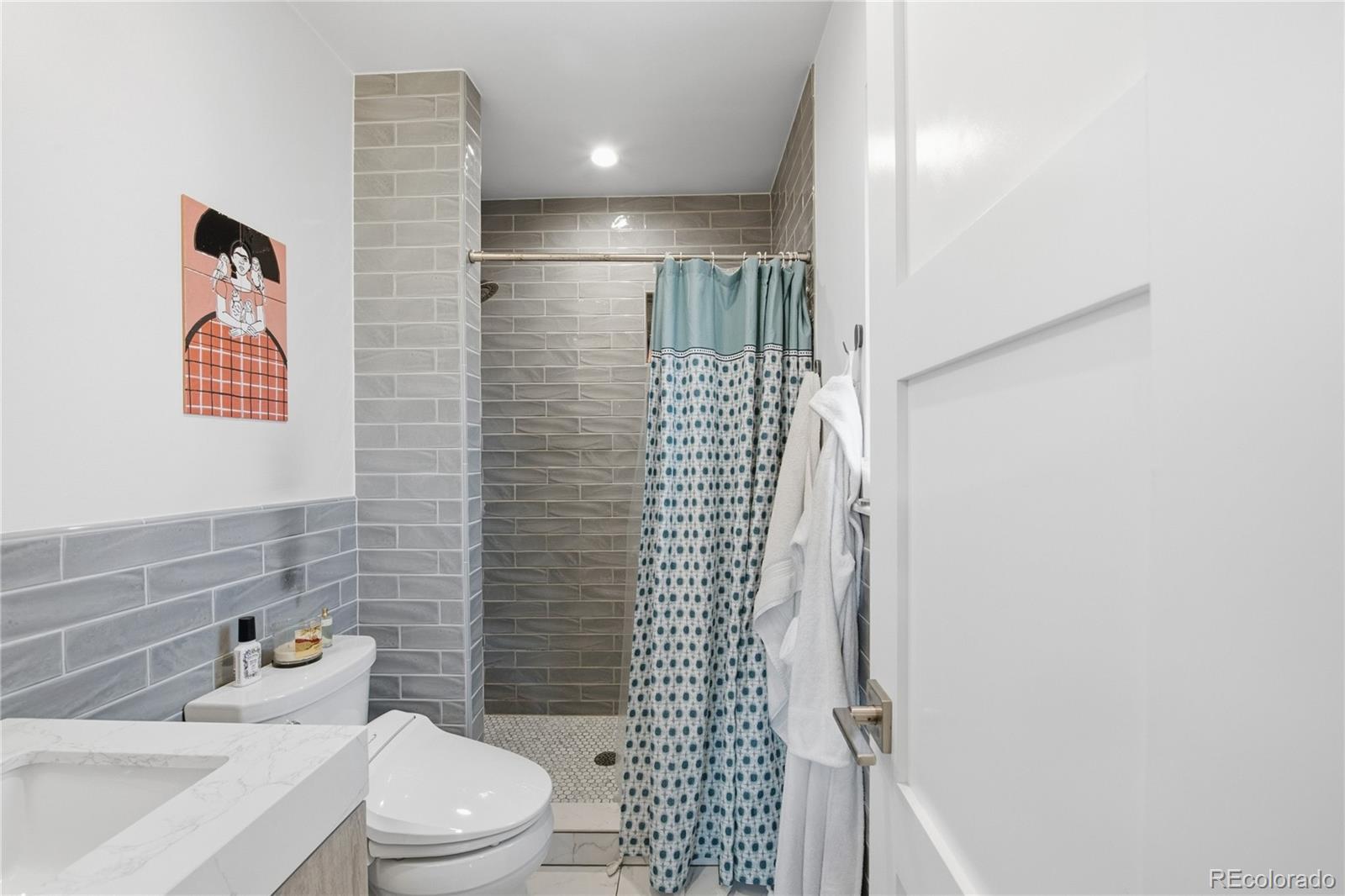 5974 South Pennsylvania Street Centennial, CO 80121 - Photo 15 of 46 a bathroom with a toilet and shower
