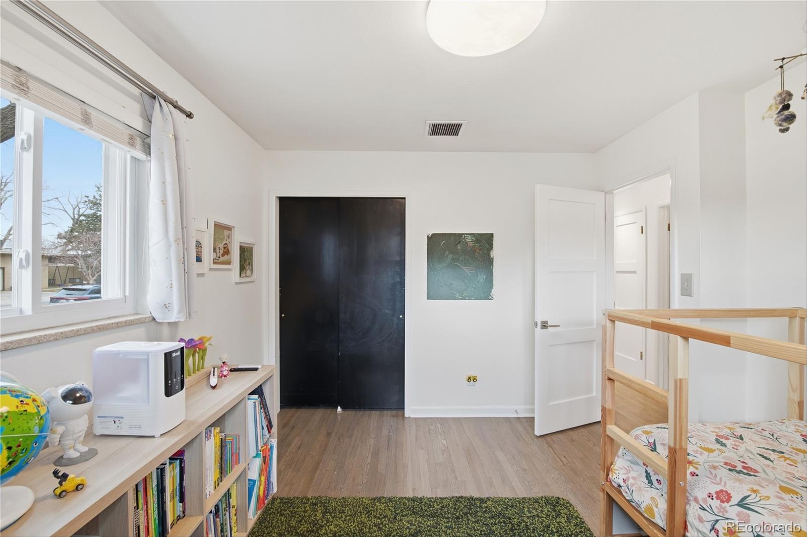 5974 South Pennsylvania Street Centennial, CO 80121 - Photo 17 of 46 a bedroom with furniture a baby crib and a window