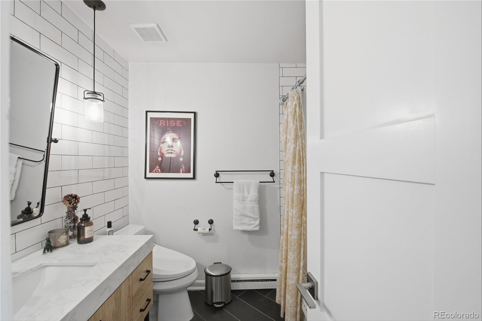 5974 South Pennsylvania Street Centennial, CO 80121 - Photo 18 of 46 a bathroom with a sink toilet and vanity