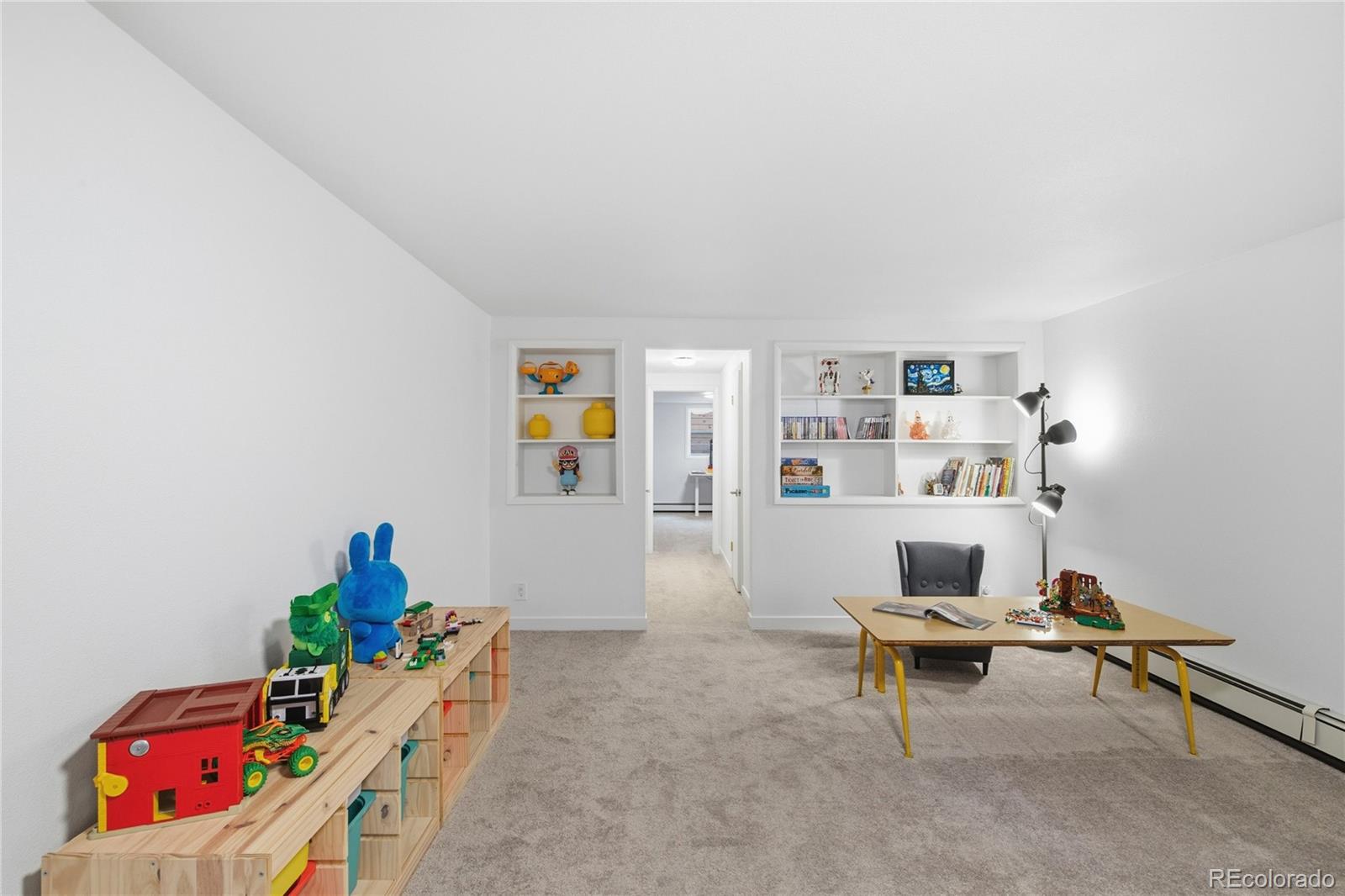 5974 South Pennsylvania Street Centennial, CO 80121 - Photo 24 of 46 a living room with furniture and book shelf
