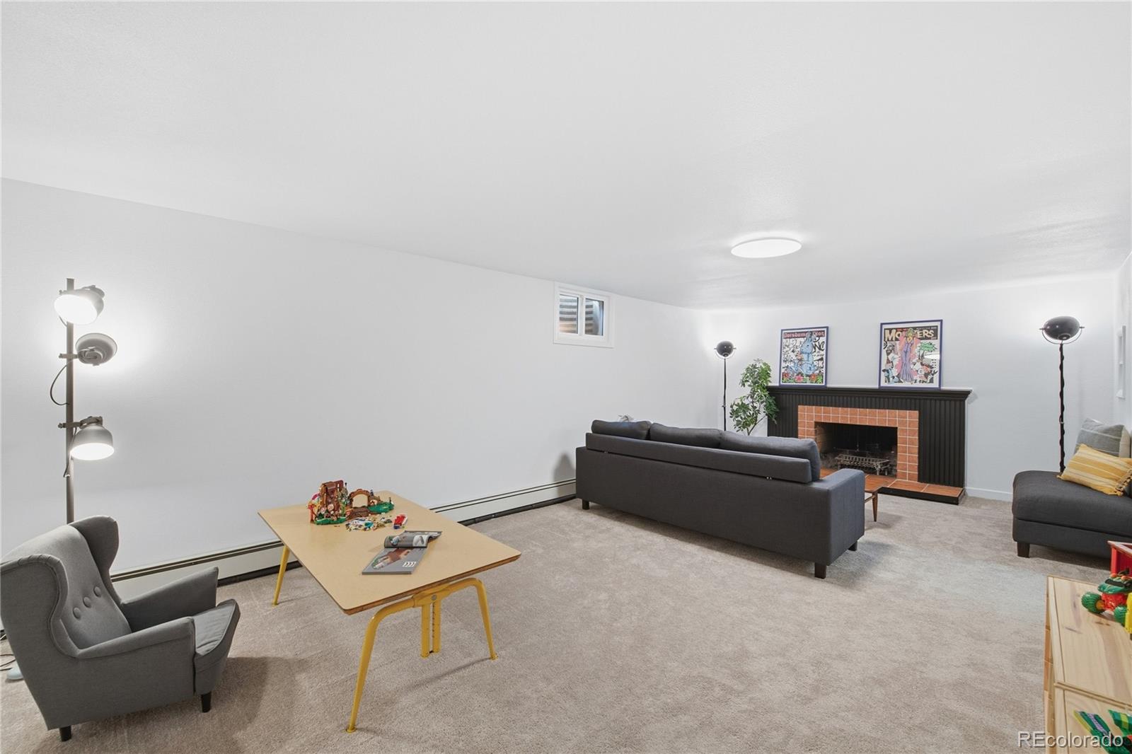 5974 South Pennsylvania Street Centennial, CO 80121 - Photo 25 of 46 a living room with furniture and a fireplace