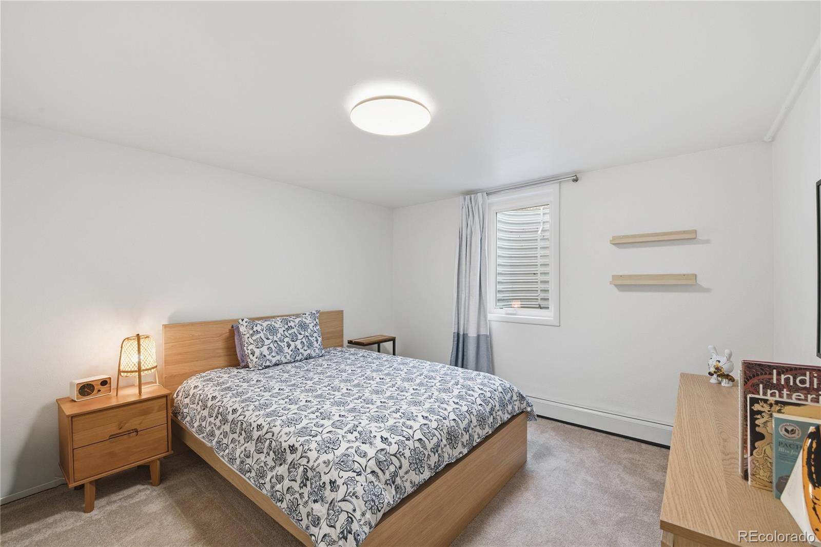 5974 South Pennsylvania Street Centennial, CO 80121 - Photo 26 of 46 a bedroom with a bed and wooden floor