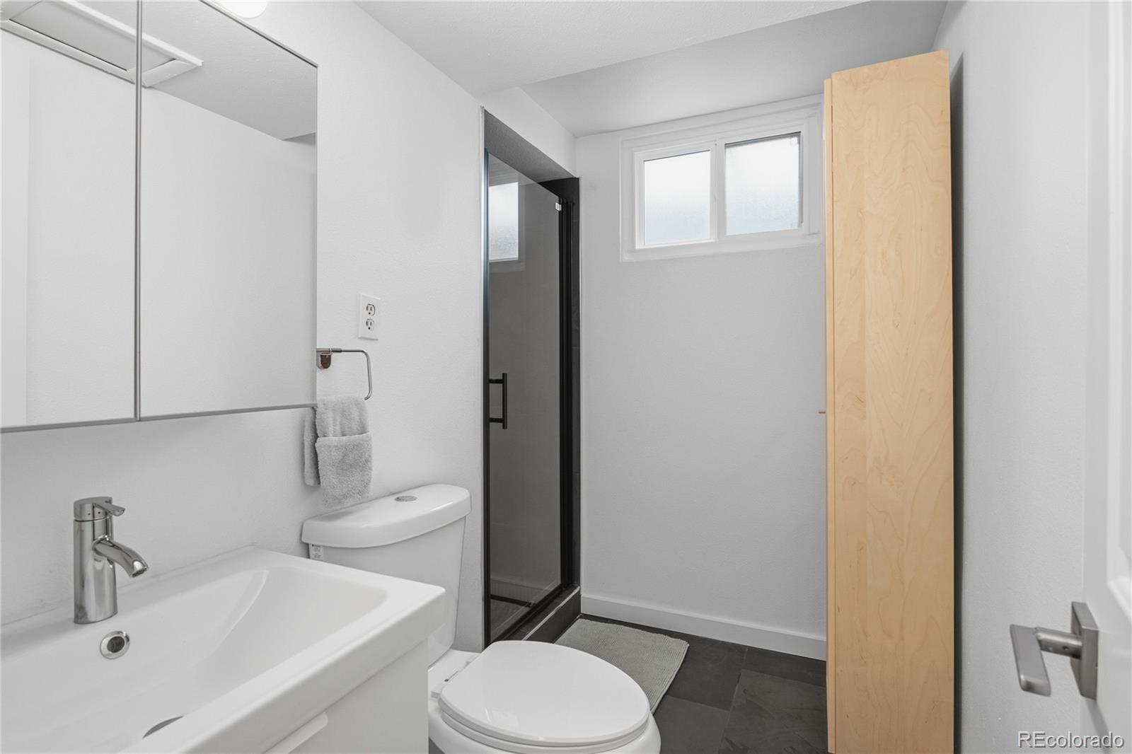 5974 South Pennsylvania Street Centennial, CO 80121 - Photo 27 of 46 a bathroom with a sink toilet and shower