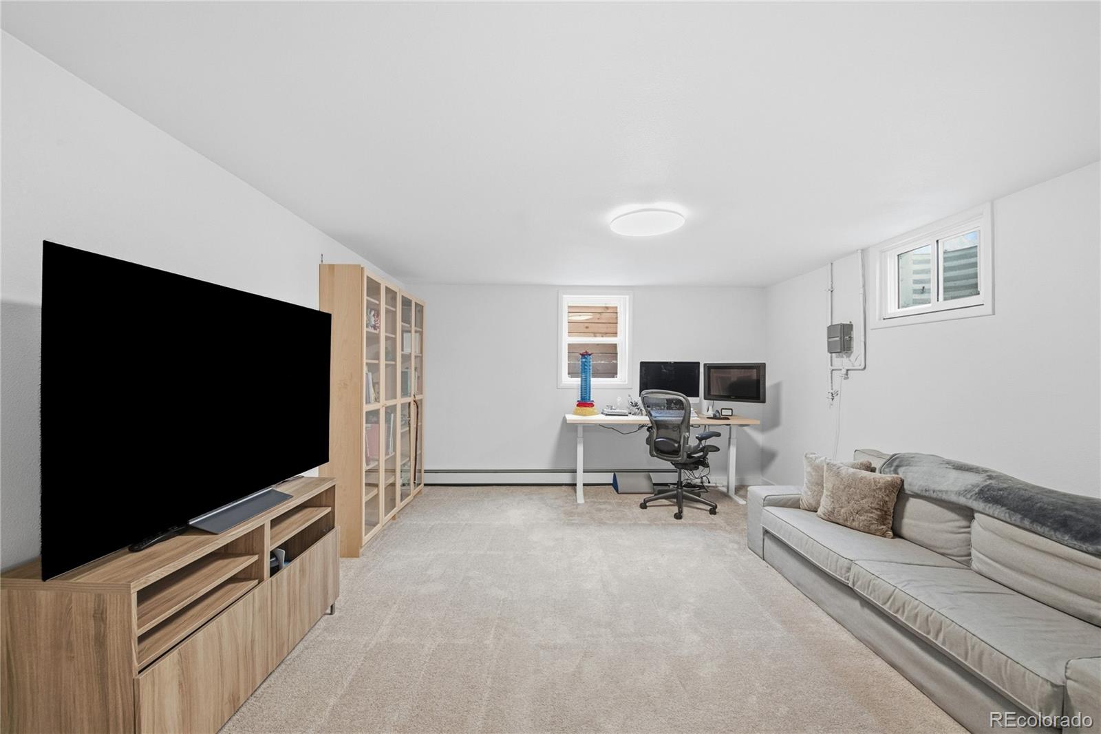 5974 South Pennsylvania Street Centennial, CO 80121 - Photo 28 of 46 a living room with furniture and a flat screen tv