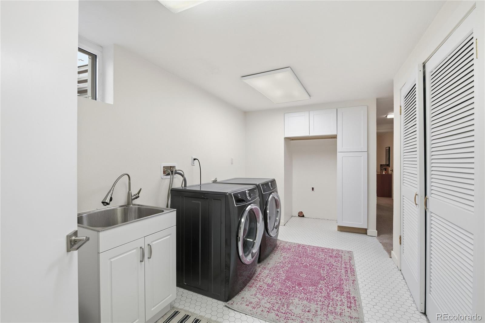5974 South Pennsylvania Street Centennial, CO 80121 - Photo 30 of 46 a view of a storage & utility room with washer and dryer