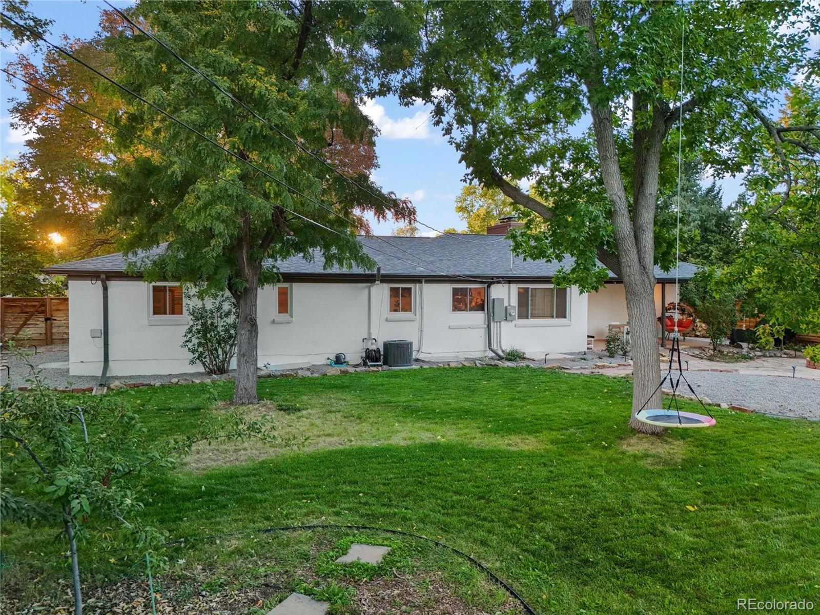 5974 South Pennsylvania Street Centennial, CO 80121 - Photo 38 of 46 a backyard of a house with plants and large tree