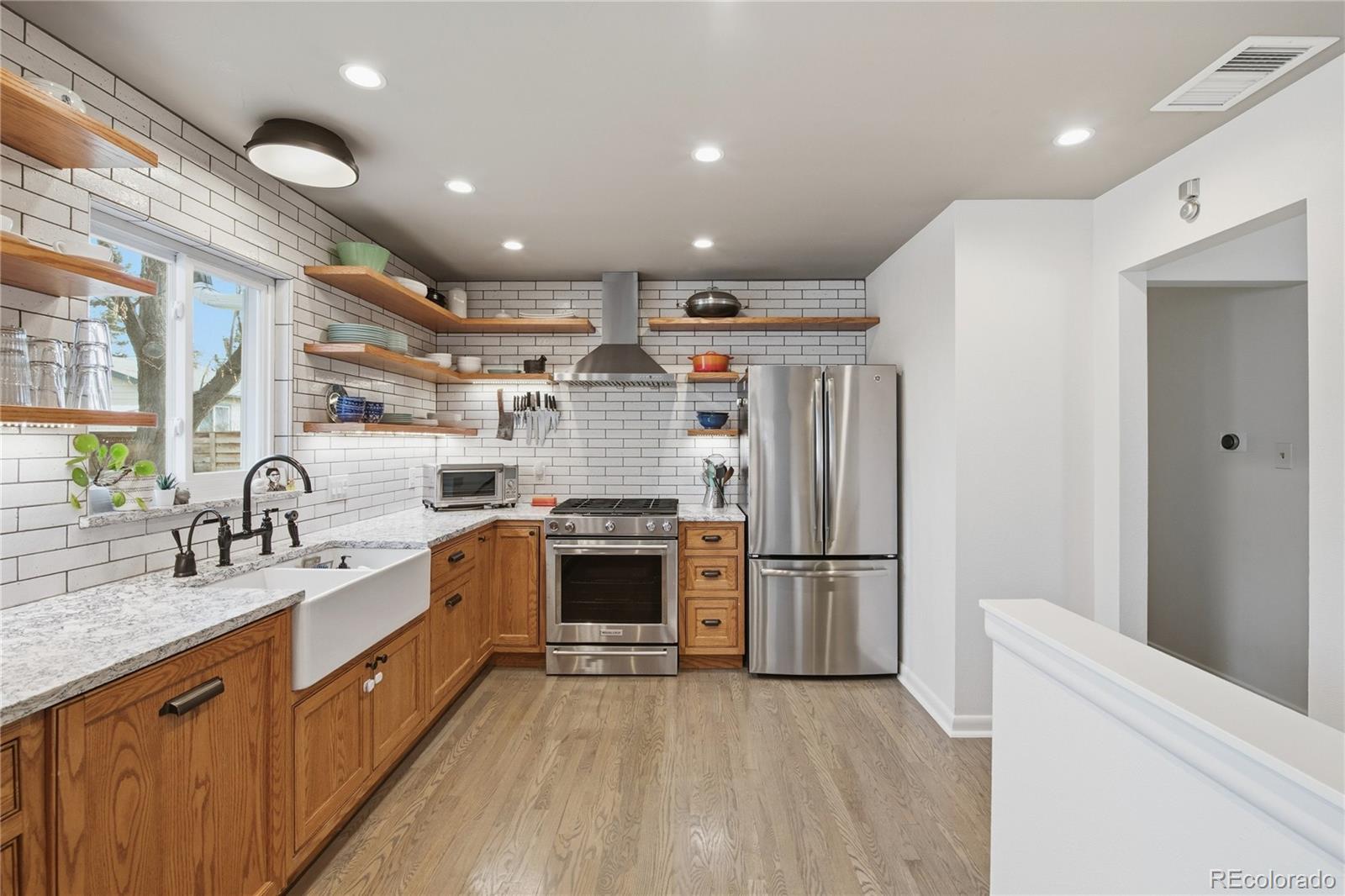 5974 South Pennsylvania Street Centennial, CO 80121 - Photo 9 of 46 a large kitchen with stainless steel appliances sink a microwave and cabinets