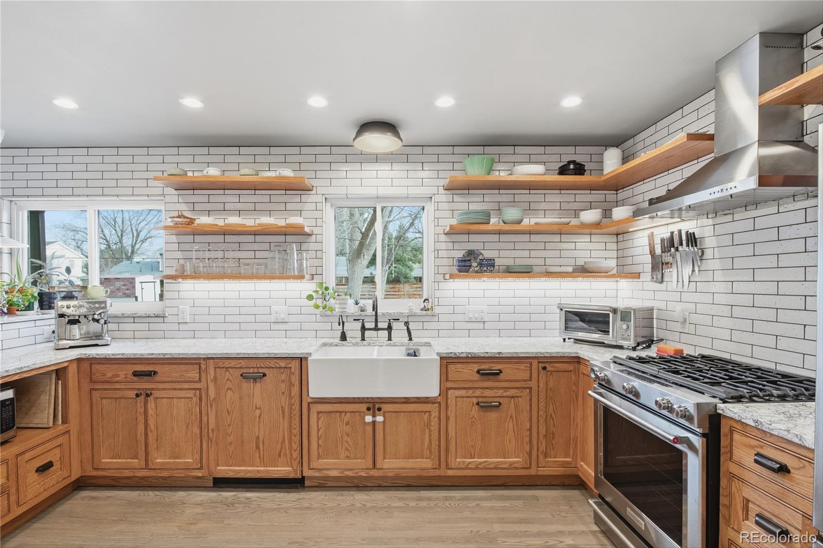 5974 South Pennsylvania Street Centennial, CO 80121 - Photo 10 of 46 a kitchen with a stove and cabinets