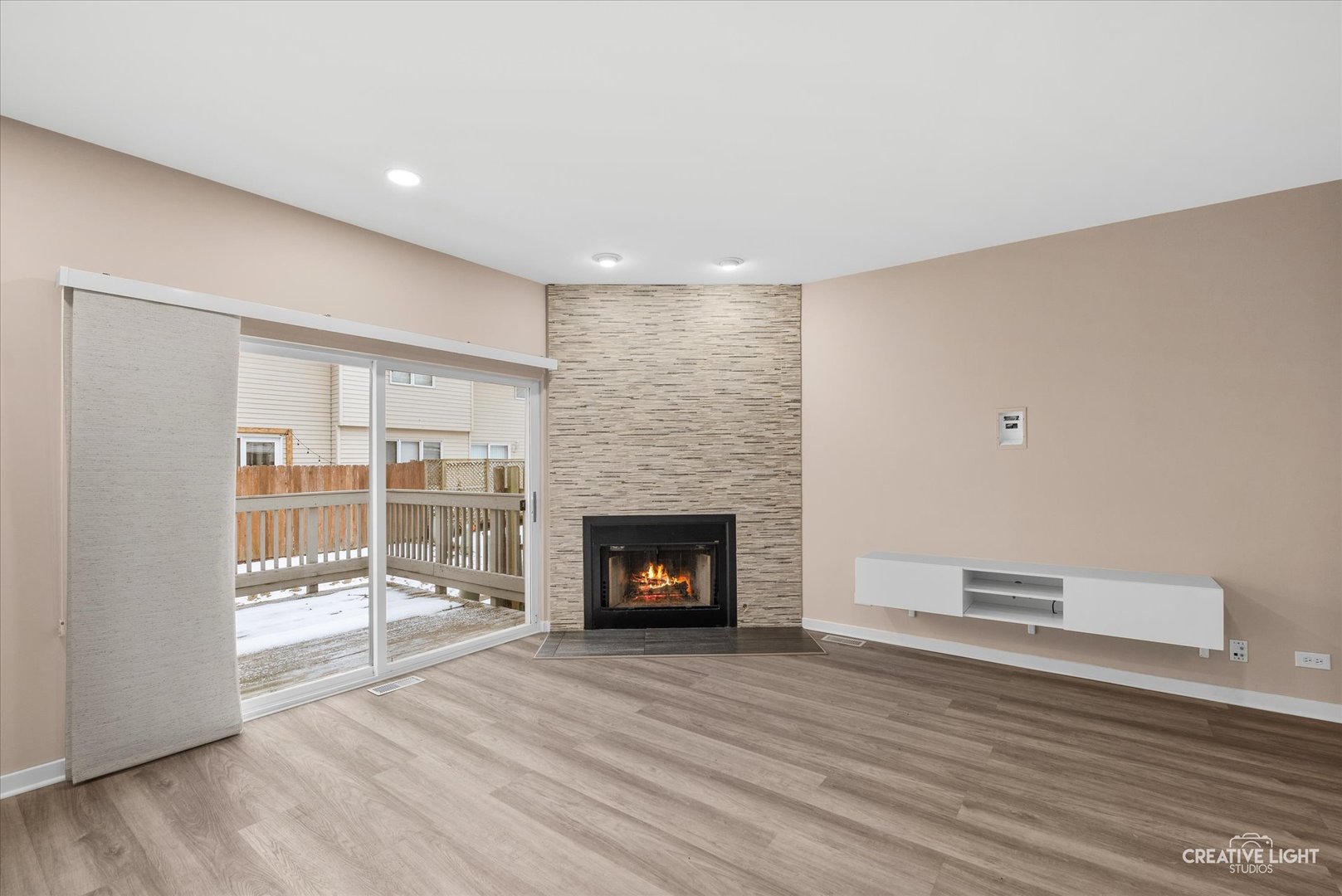1935 Calla Drive Joliet, IL 60435 - Photo 6 of 17 a view of an empty room with wooden floor and a fireplace